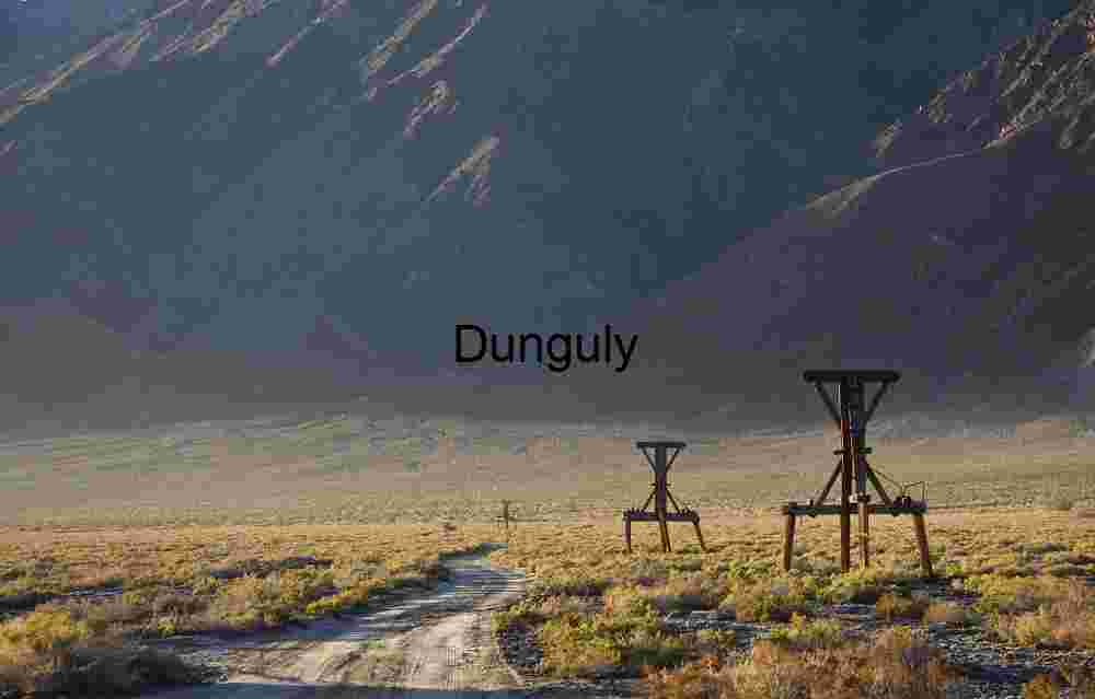 Rusting Oil Derrick Against Rugged Peaks