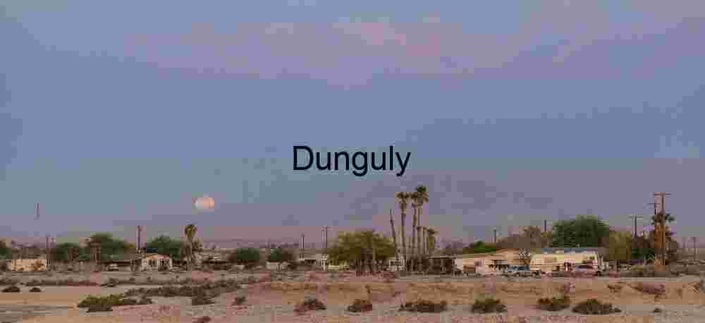 Moonrise Over Desert Townscape at Twilight
