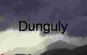 Sunbeams Over Layered Mountain Ranges Beneath Moody Sky