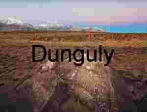 Twilight Petroglyphs: Ancient Symbols on Desert Stone Beneath Moonlit Peaks