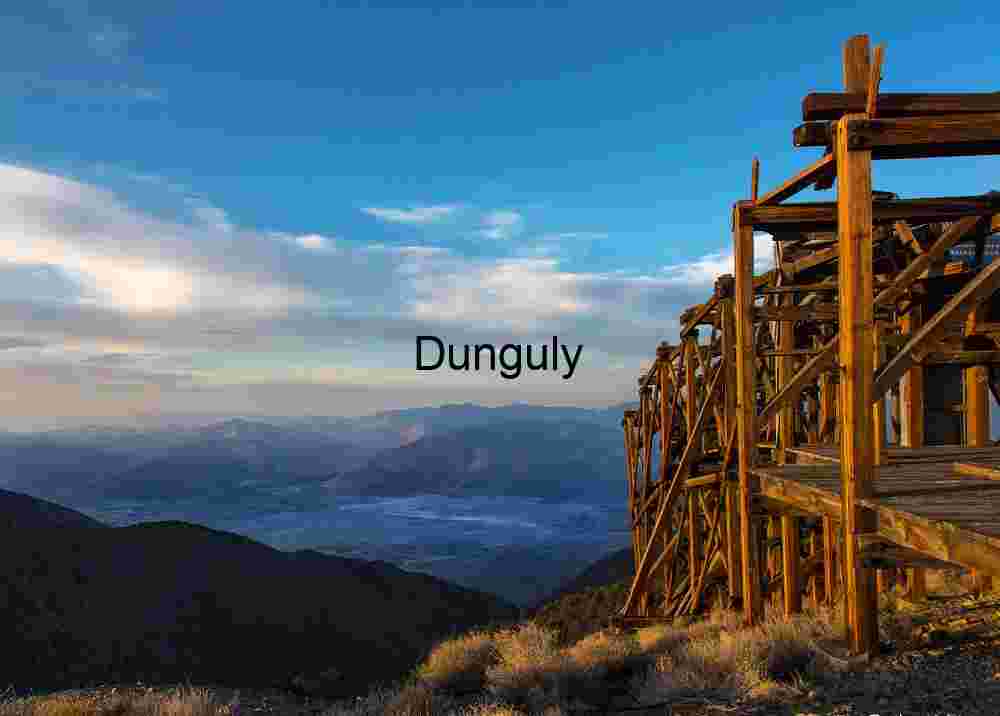 Weathered Wooden Mining Structure Overlooking Mountain Valley at Sunset