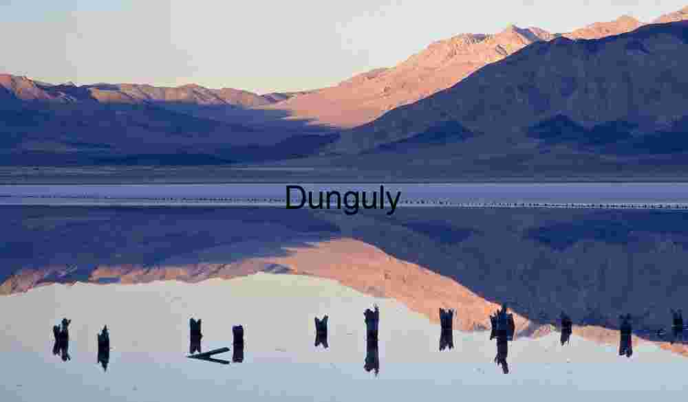 Reflective Mountain Lake with Weathered Wooden Posts