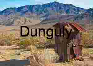 Shelter in Silence: Rusted Outhouse Beneath Desert Peaks
