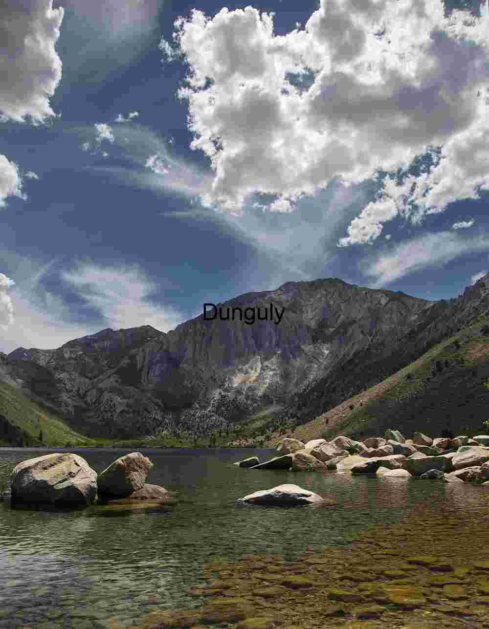 Veil of Light: Mountain Reflections Beneath Shifting Skies