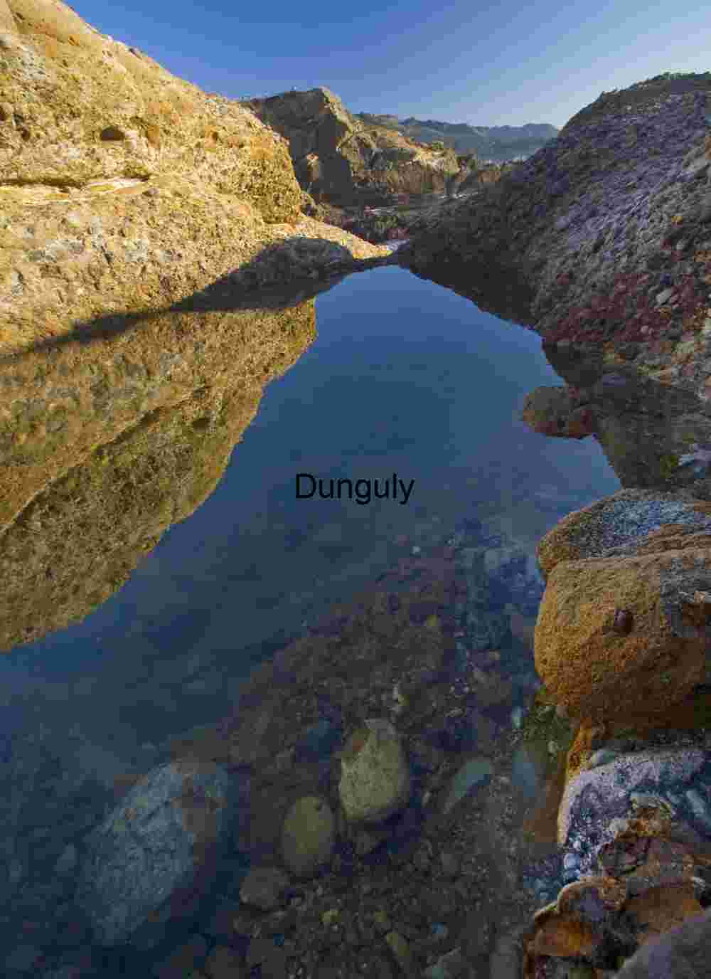 Geological Water Pocket in Arid Canyon with Transparent Stream