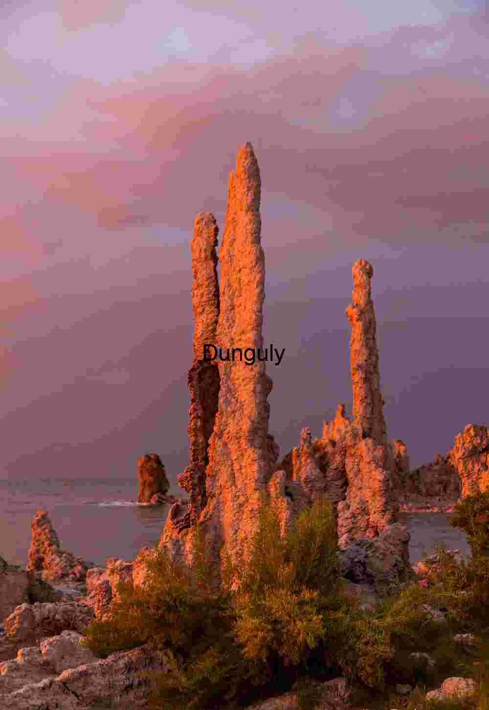 Sunlit Sentinels: Tufa Towers Framed by Earth and Sky