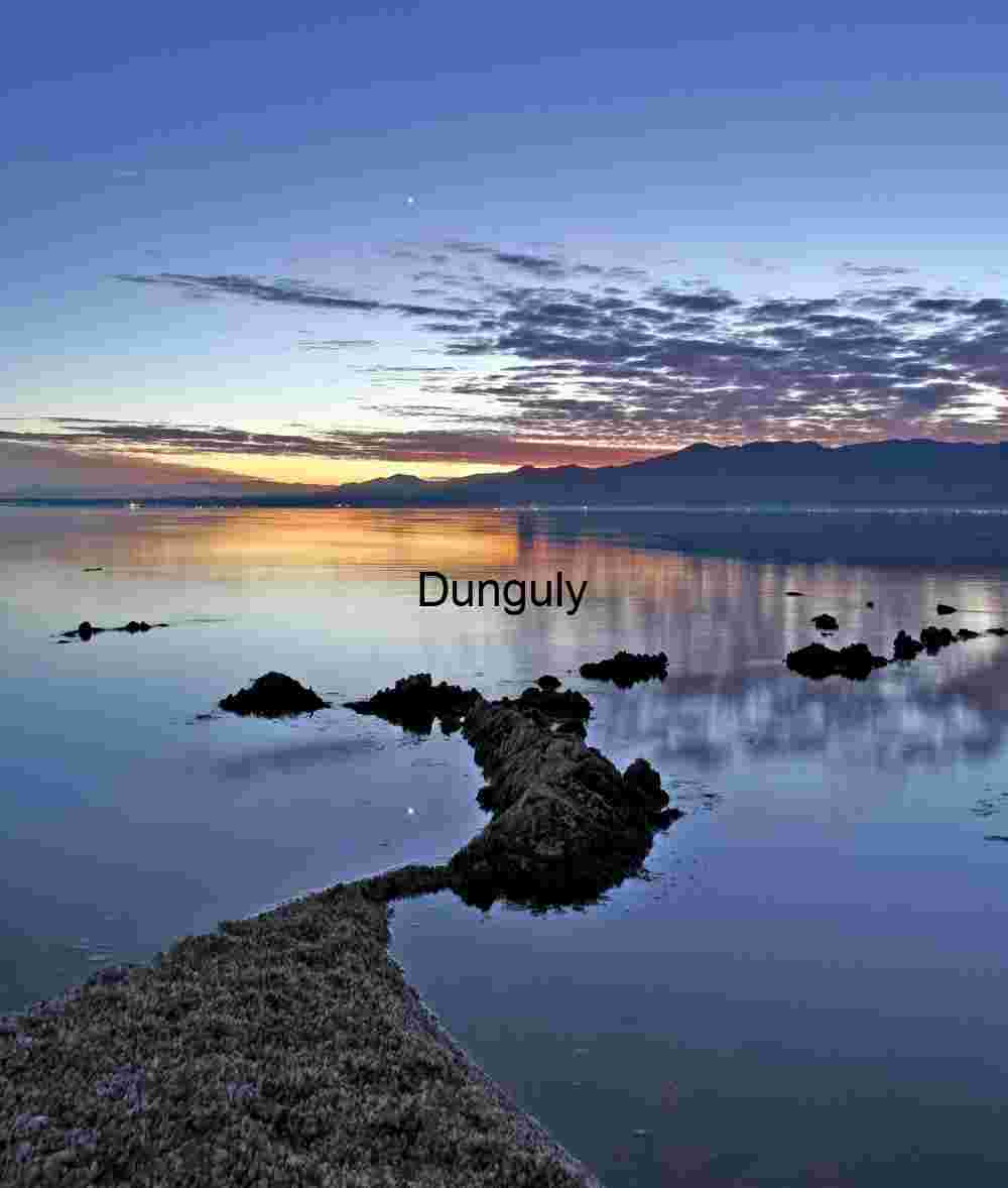 Twilight Coastal Reflections – Serene Seascape with Rocky Outcrop, Mountains, and Vibrant Horizon