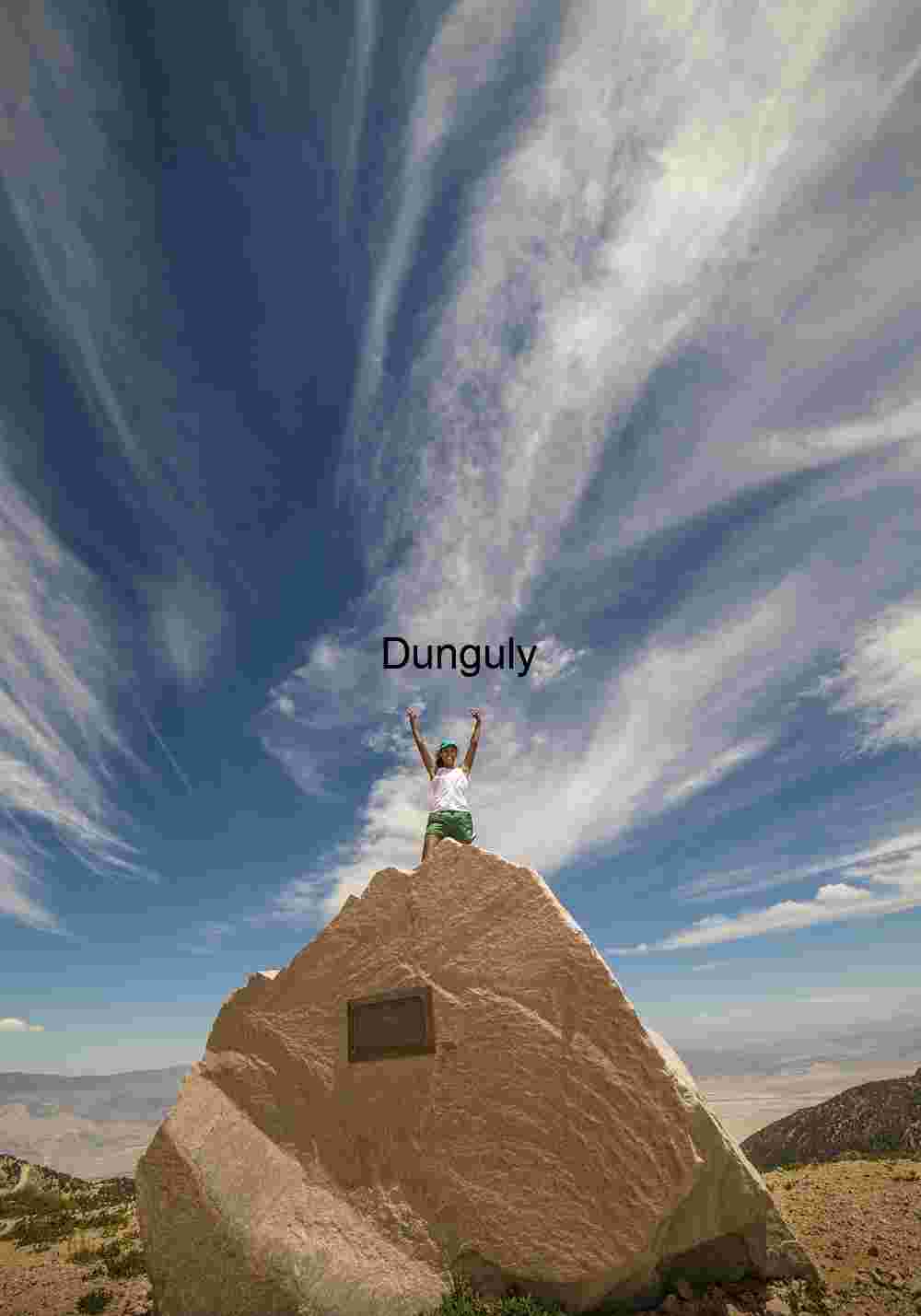 Triumphant Figure on Mountain Summit Rock – Dramatic Sky and Victorious Pose Landscape Photography