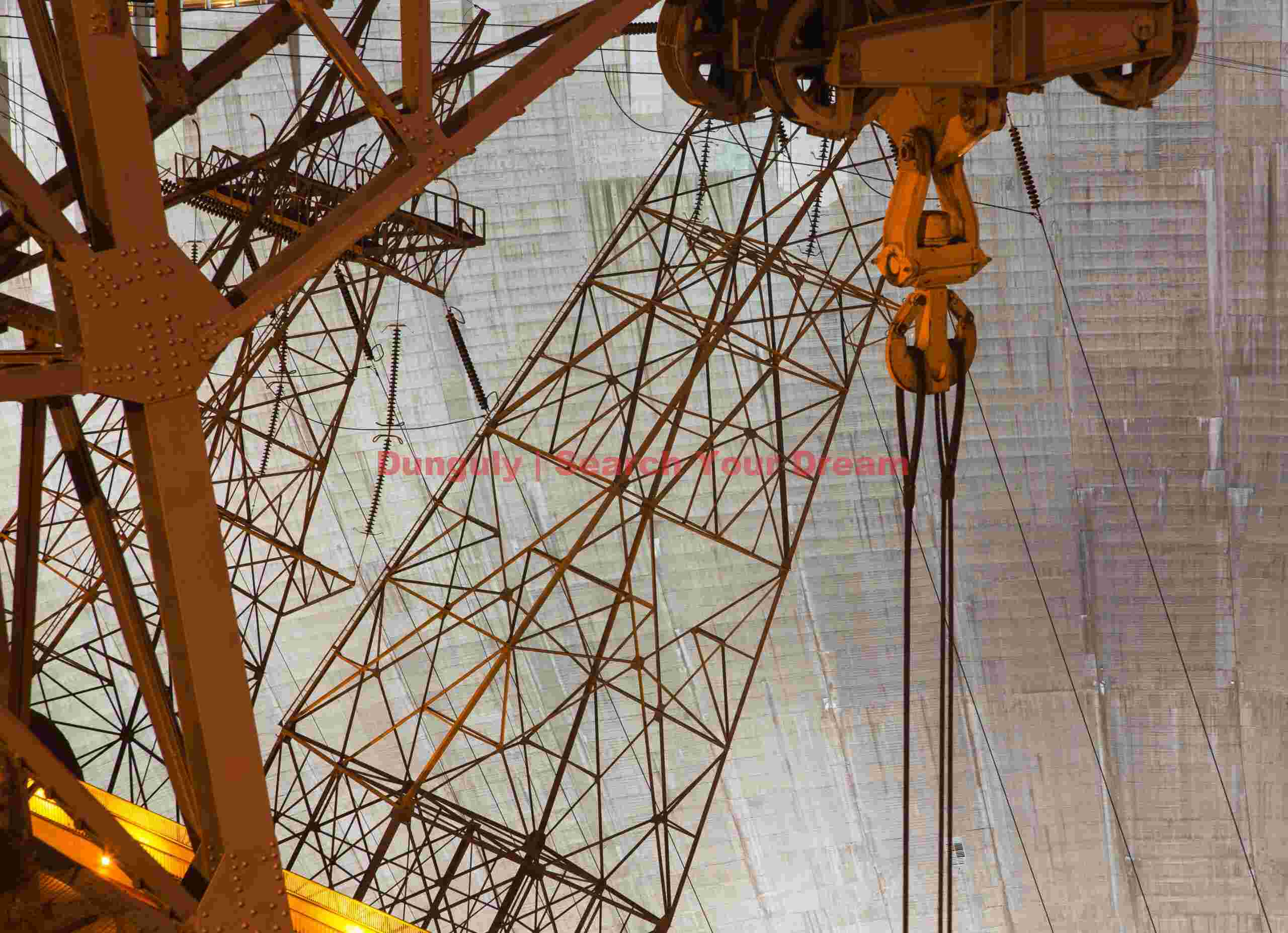 Transmission Towers and Crane Against Hoover Dam Face