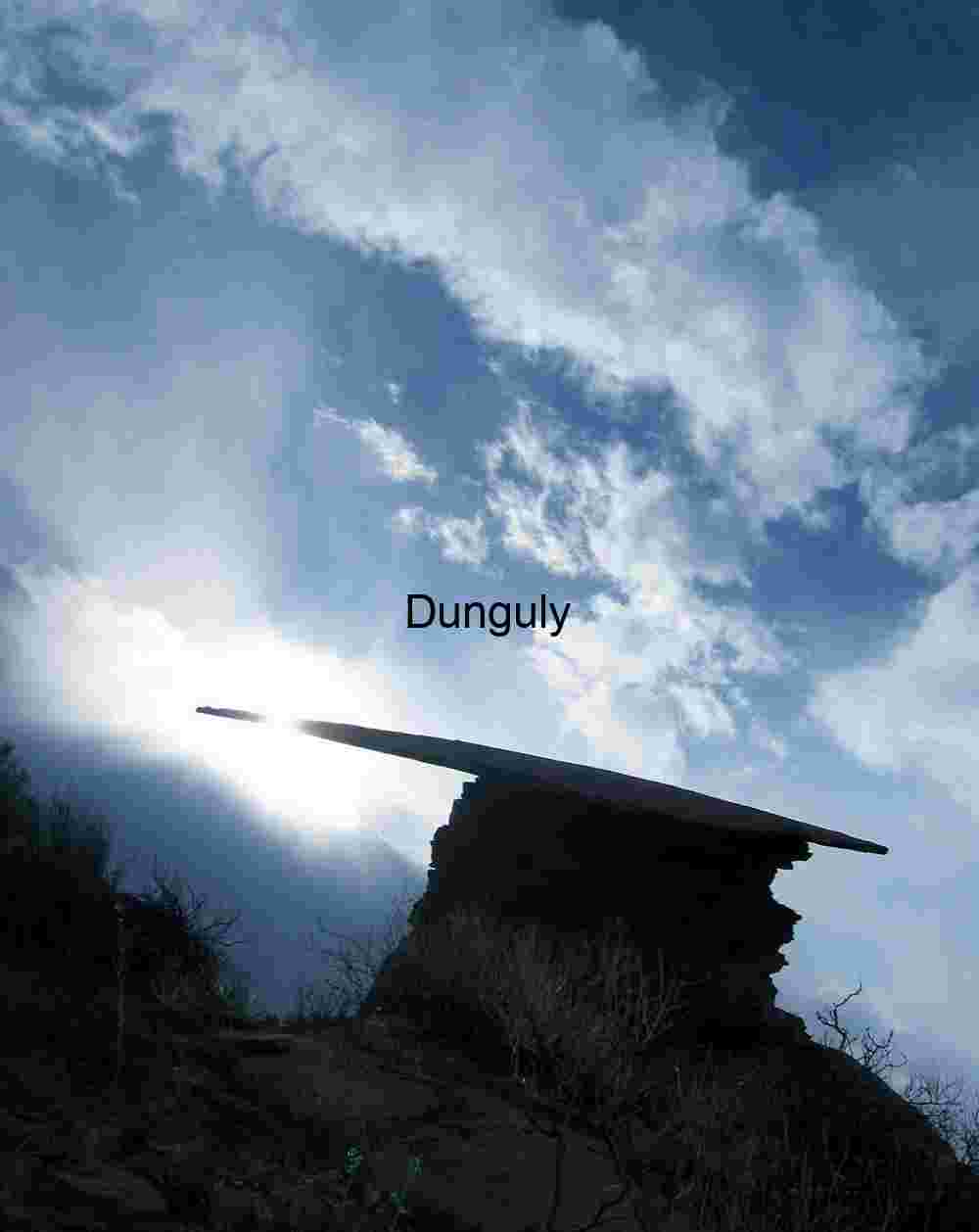 Dramatic Silhouette of Mortar Board Rock Against Sunburst Sky