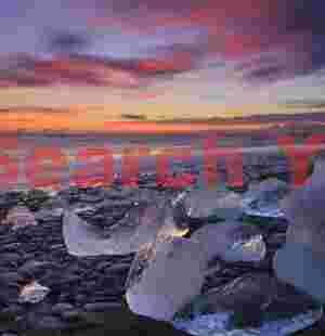 Bergs reflecting sunset sky; Jokulsarlon beach