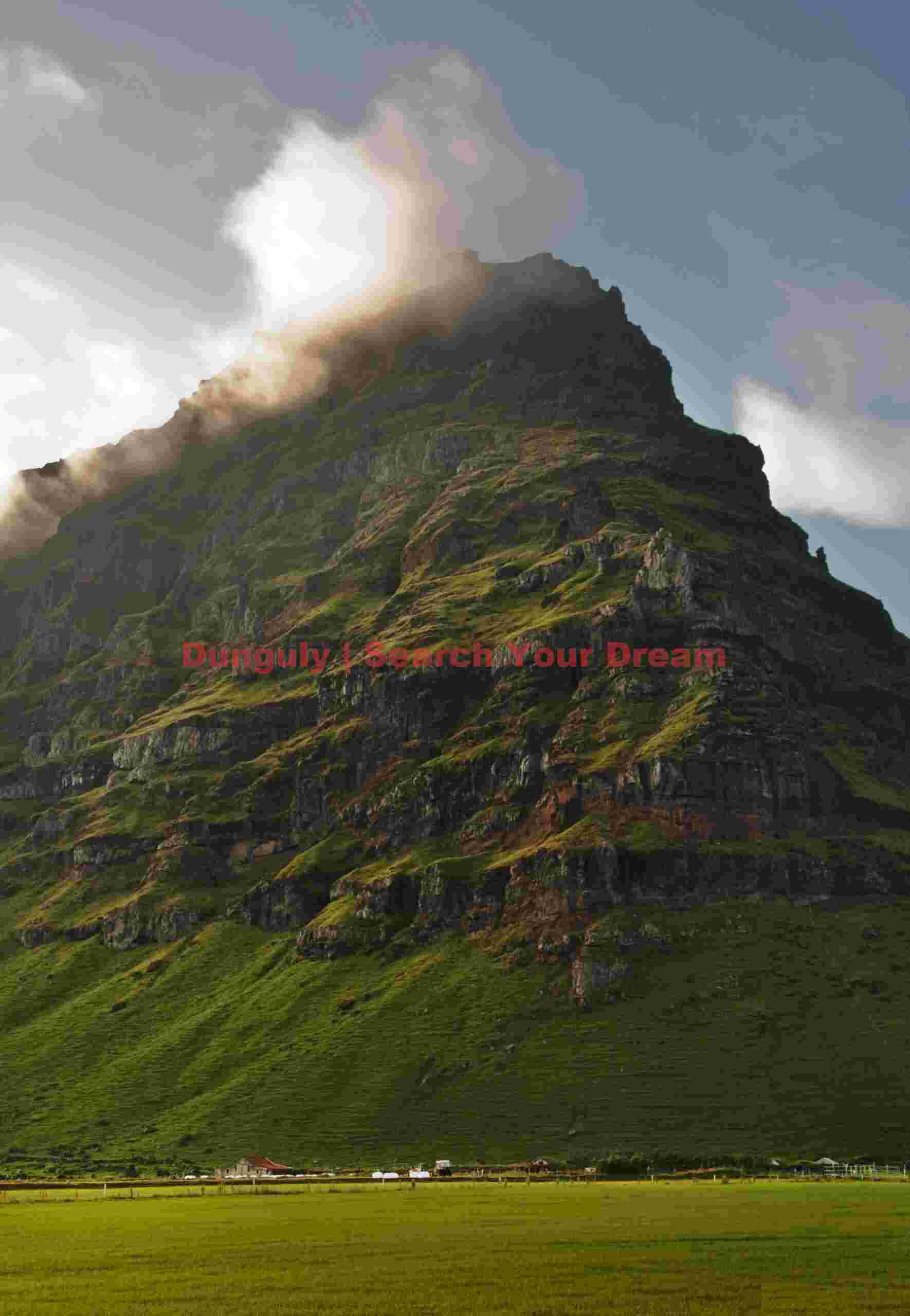 Glacial Ice Formation at Farmhouse nestled below cliff - South Iceland