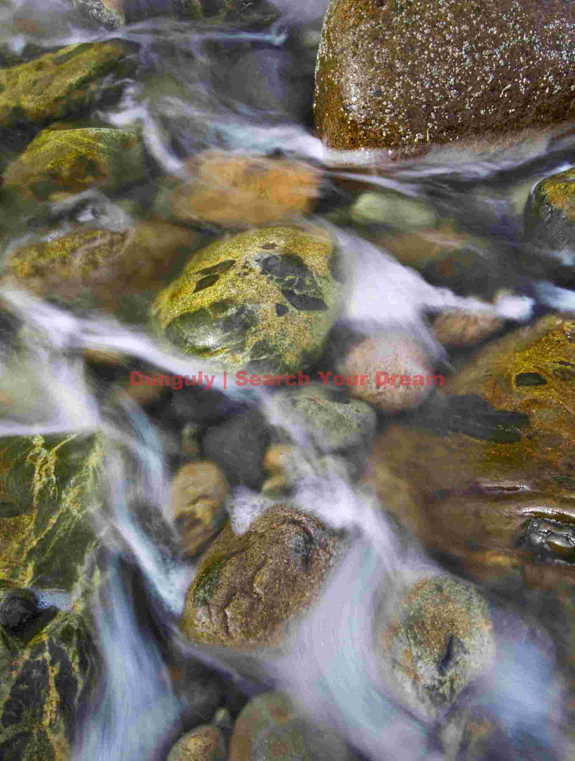 Wave Spray Receding Over Pebbles at Acadia Coastline