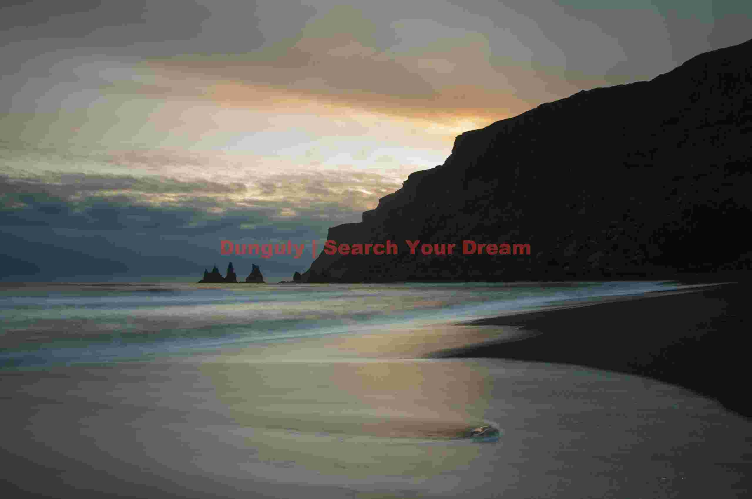 Reynisdrangar sea stacks with reflected sunset color; Vik, South Iceland