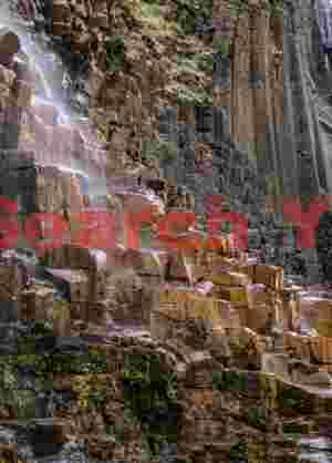 Majestic Waterfall: Small waterfall over orange basalt columns