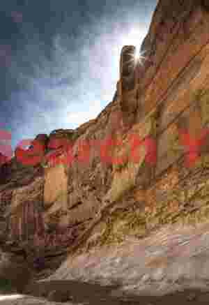 Sunstar above canyon wall - Crack Canyon - San Rafael Reef