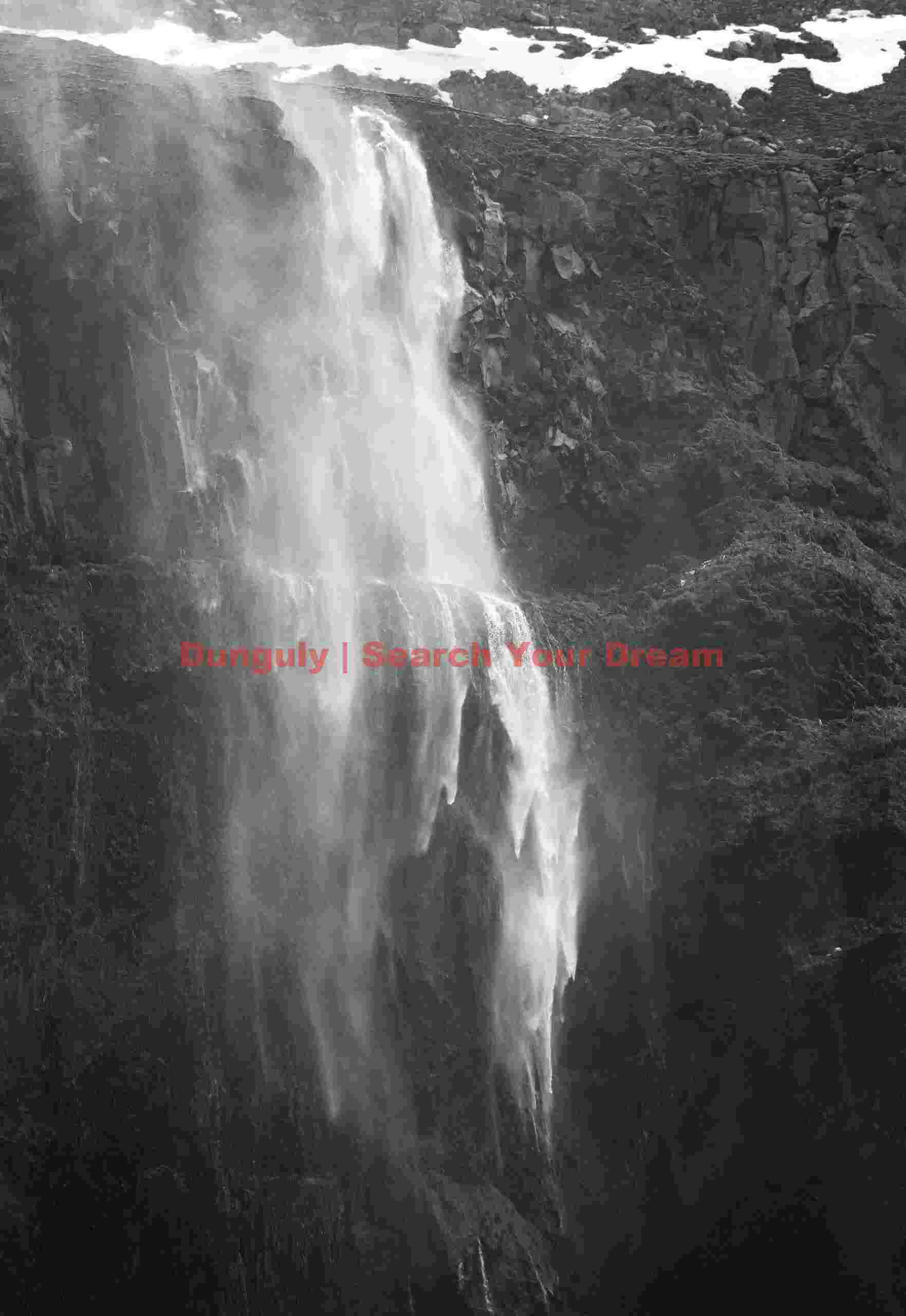 Vanishing waterfall converted to spray by gale-force winde; South Iceland