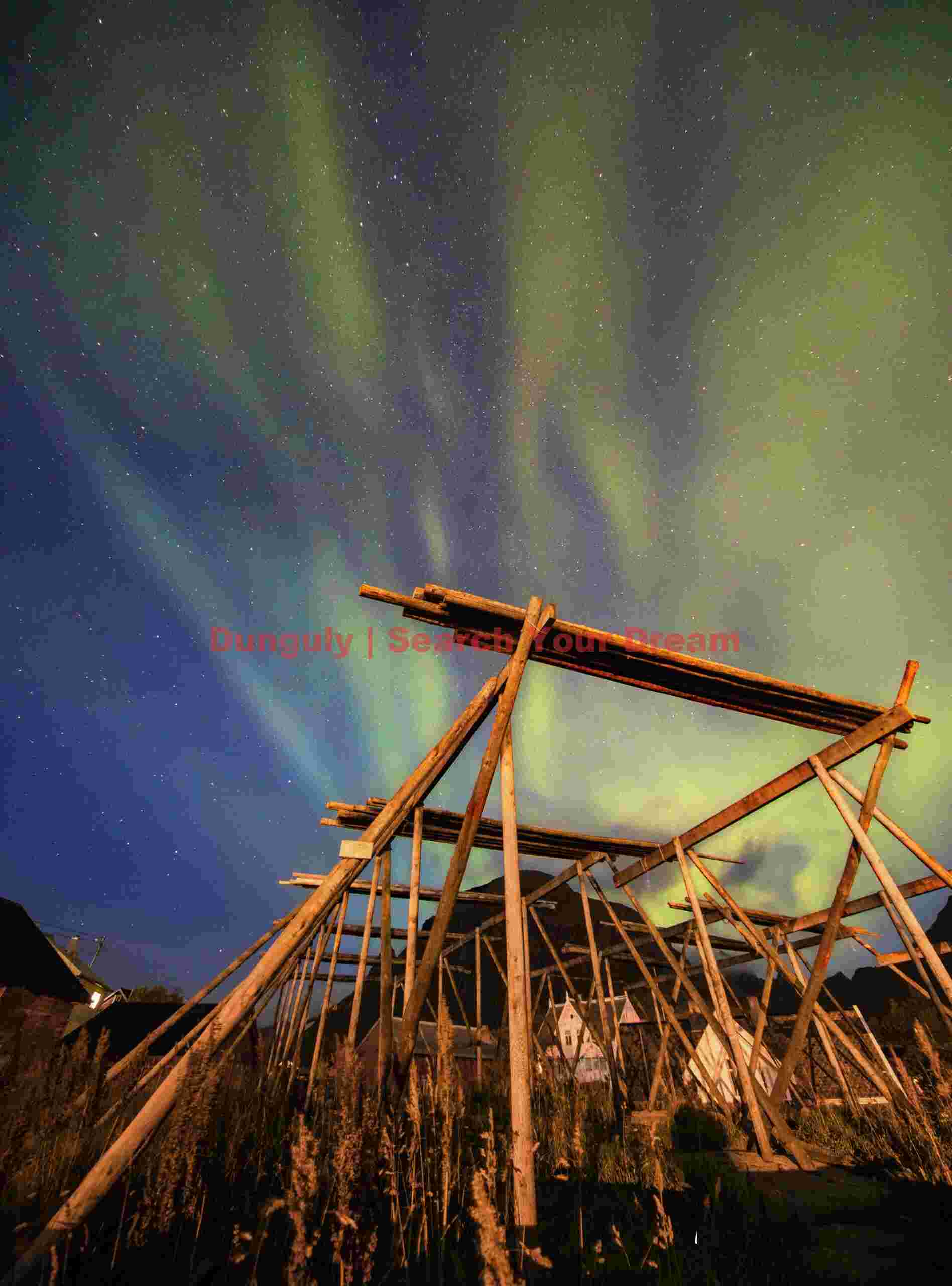 Auroral whisps above fish drying racks