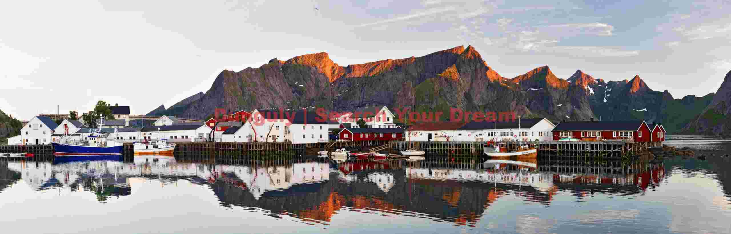 Reine panorama with golden light on mountain tops