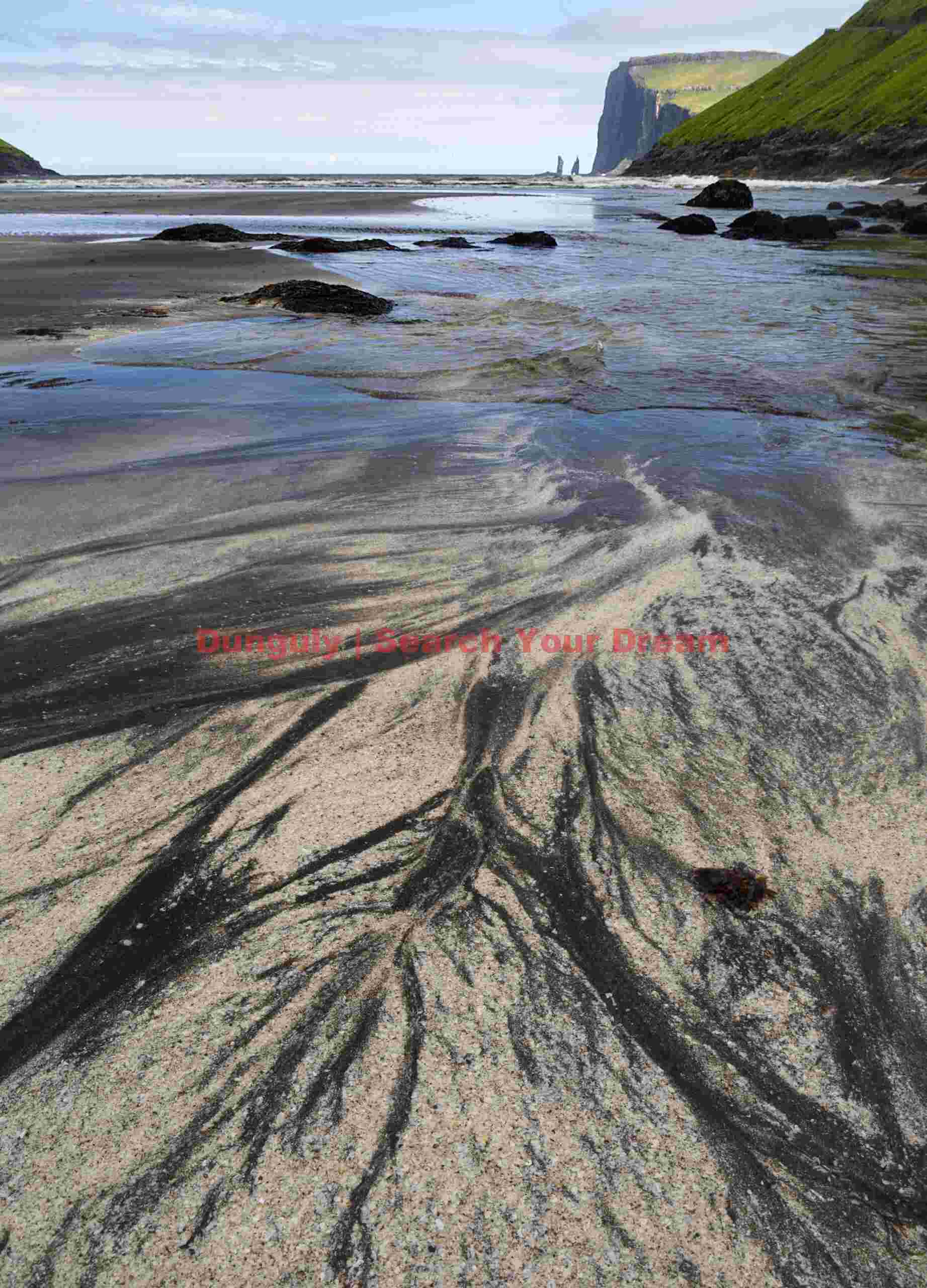 Sand patterns with distant view of Risin and Kellingin sea stacks