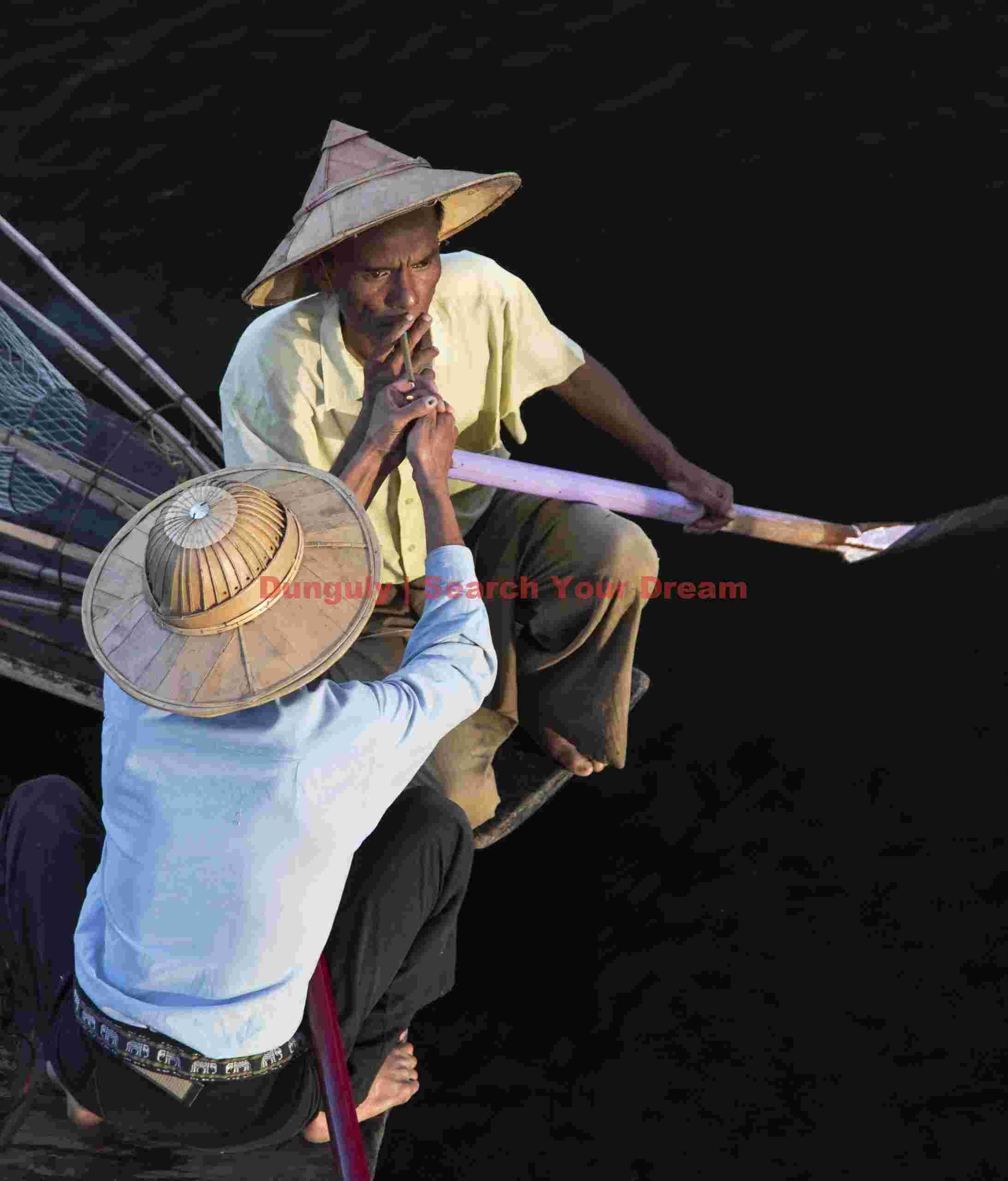 Fishermen lighting a cheroot