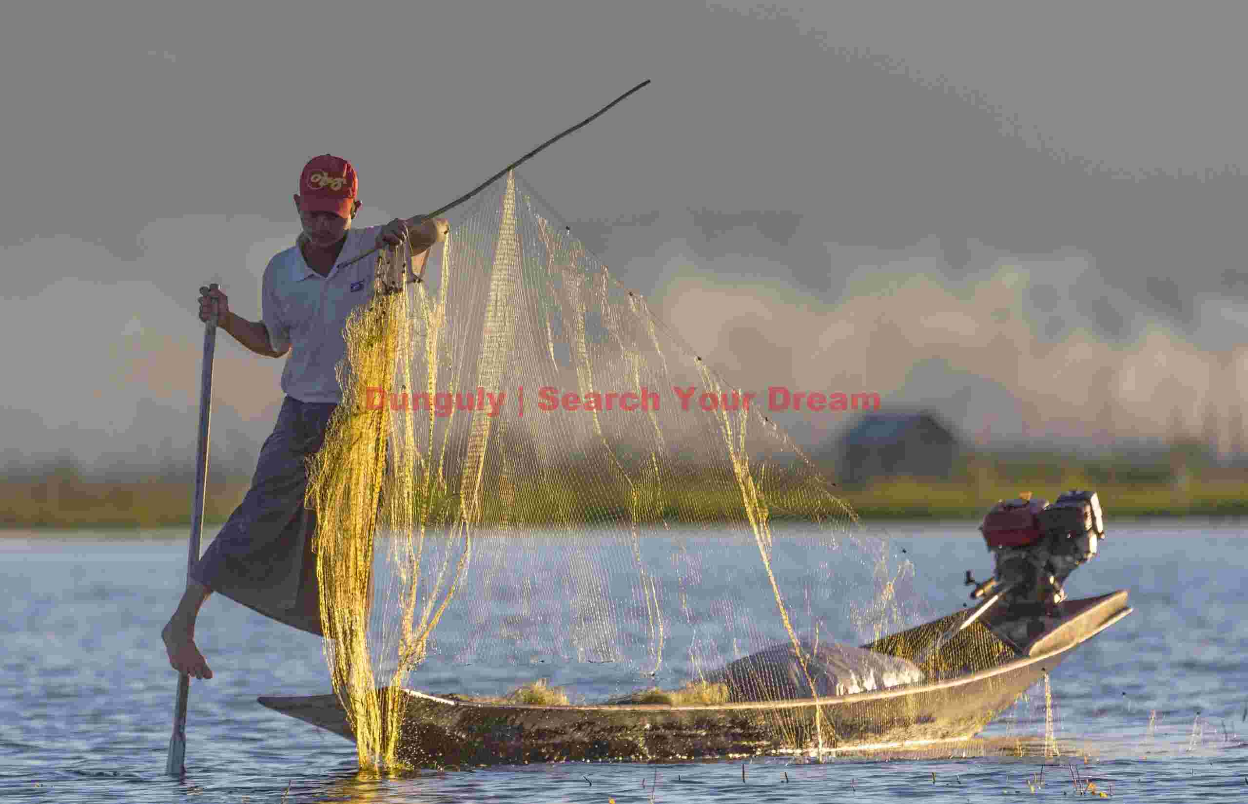 Leg-rowing fisherman with backlit net