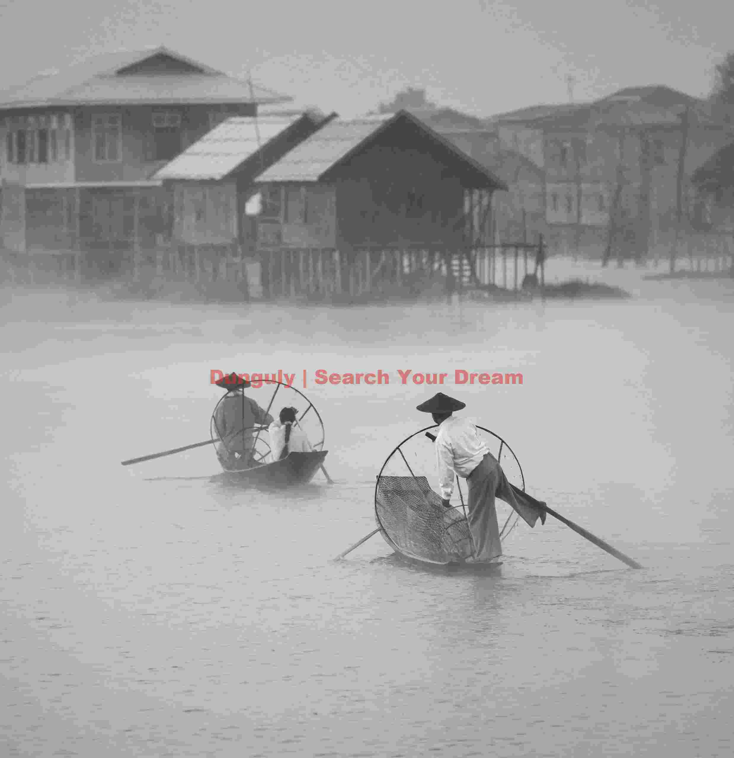Leg-rowing fishermen in mist