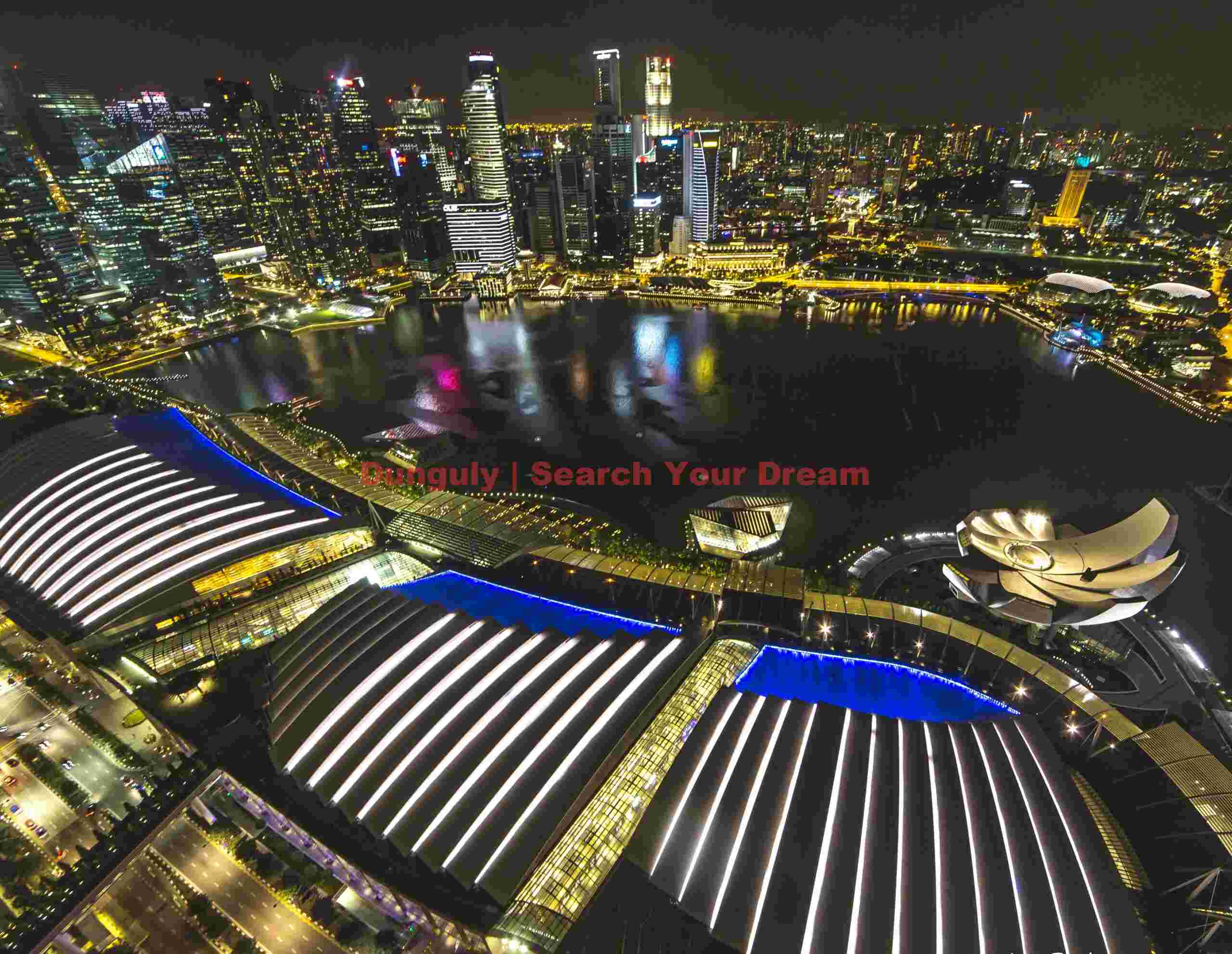 Marina Bay and Singapore skyline at night from the roof (56th floor) of the Marina Bay Sands Hotel