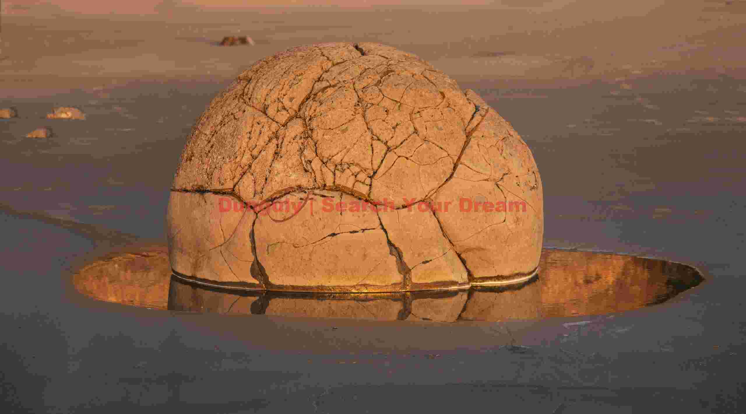 Orange orb and reflection at sunrise