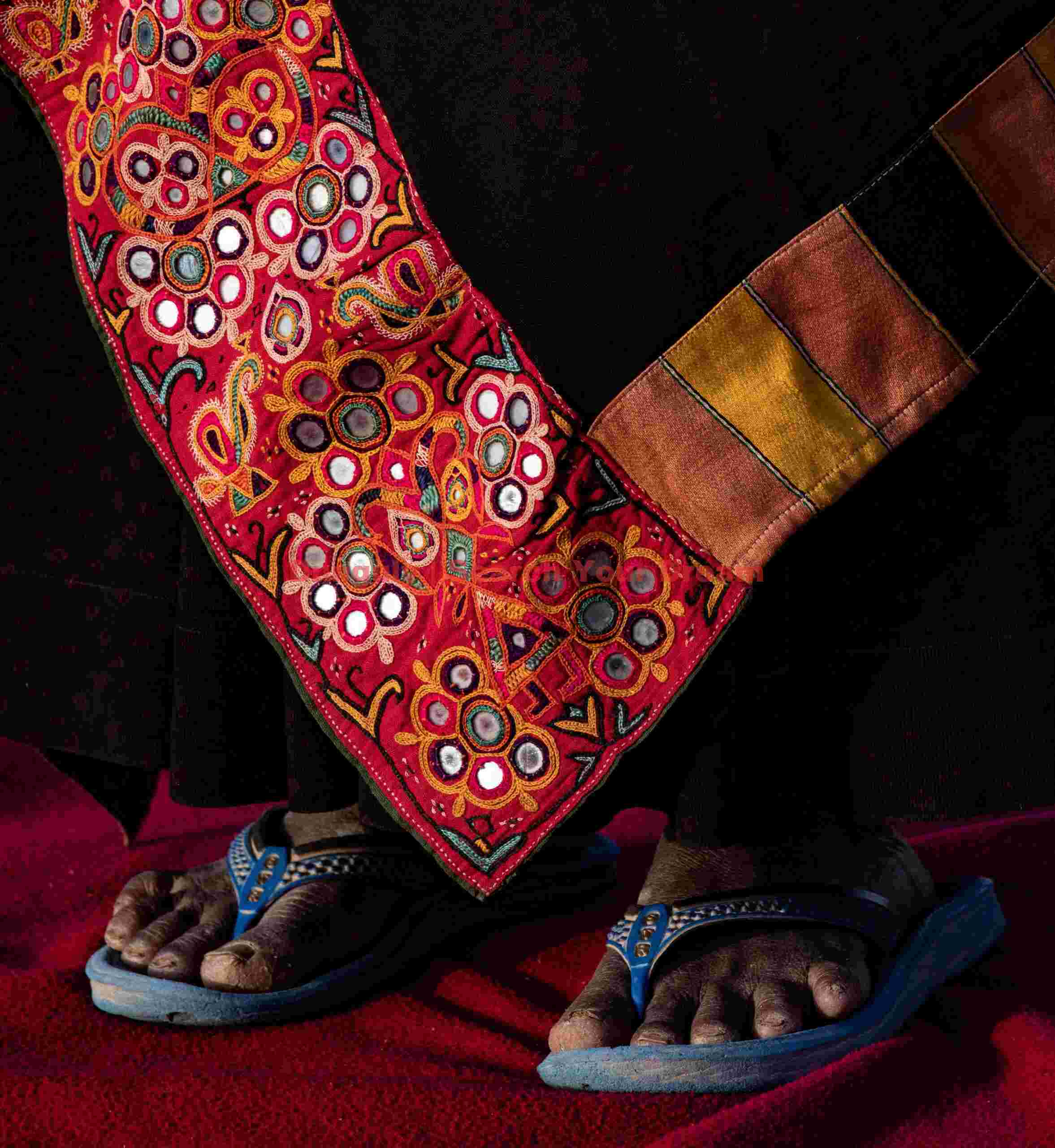 Red embroidery at foot level