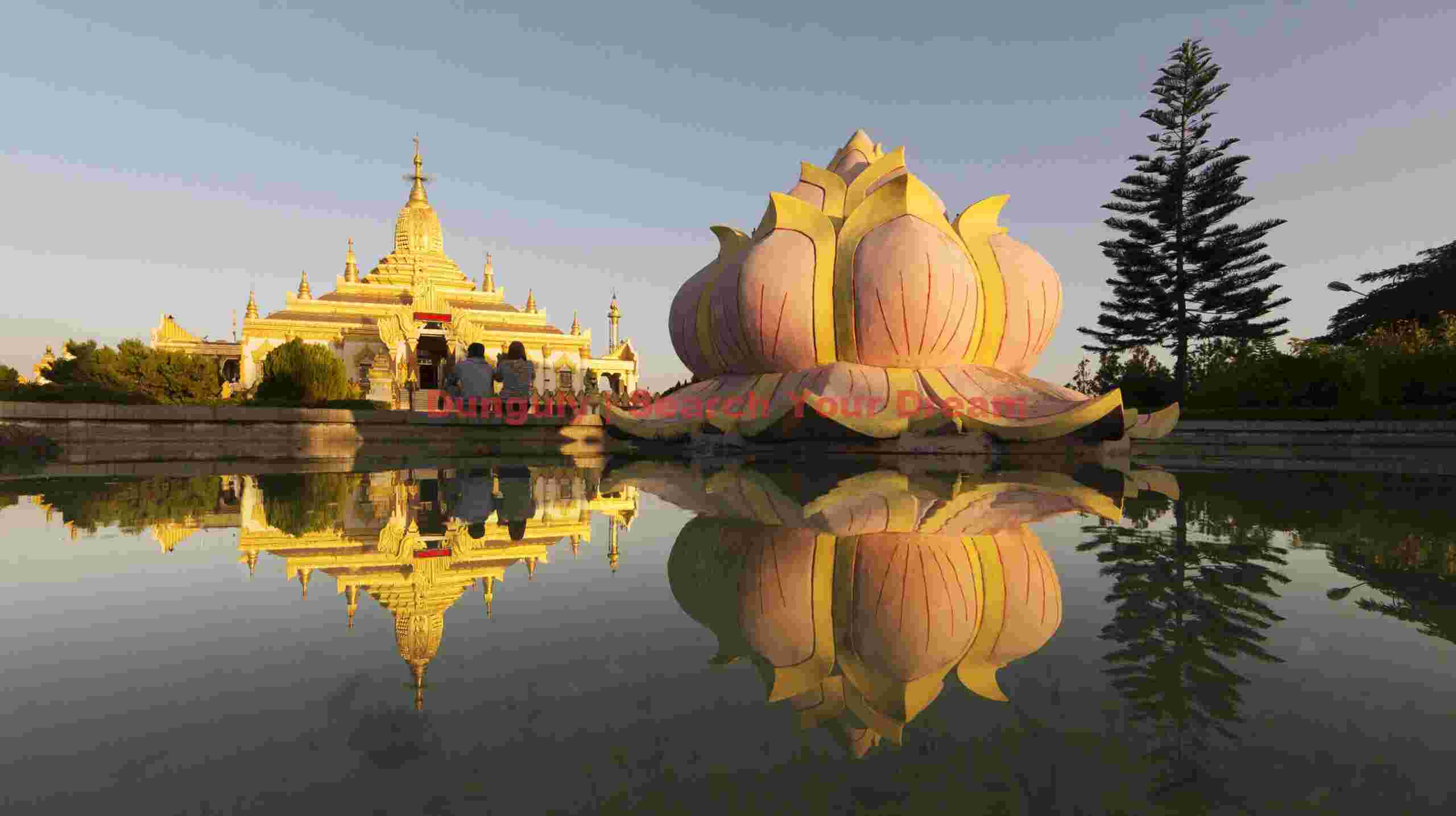 Reflections of pagoda and lotus flower sculpture