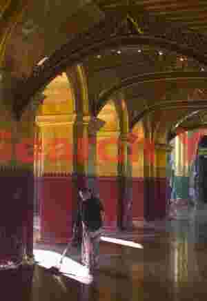 Sweeper in monastery with reflective floors