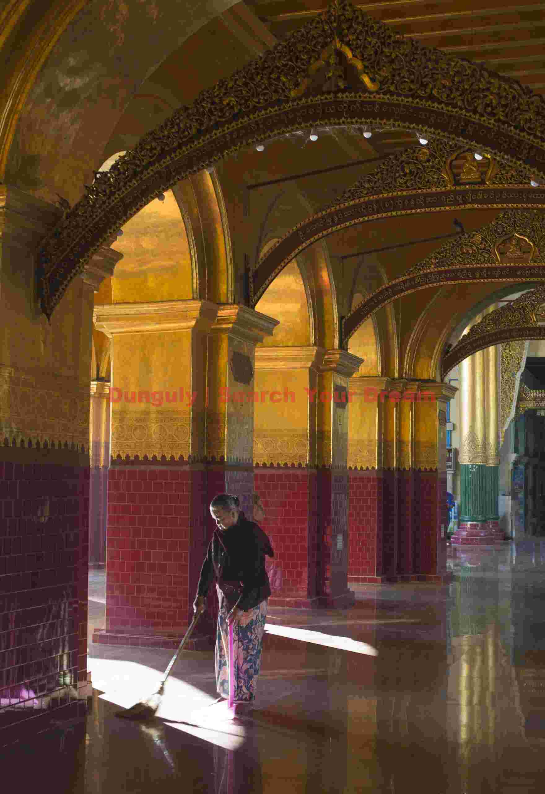 Sweeper in monastery with reflective floors