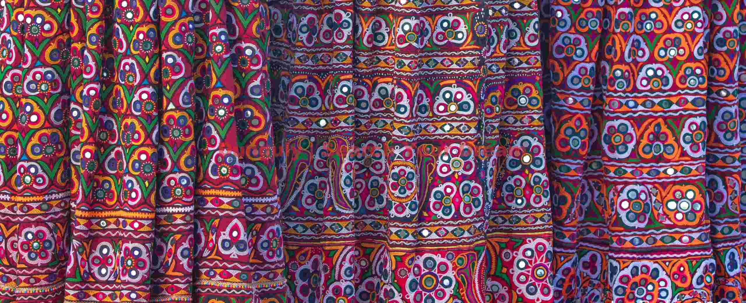 Three embroidered dresses