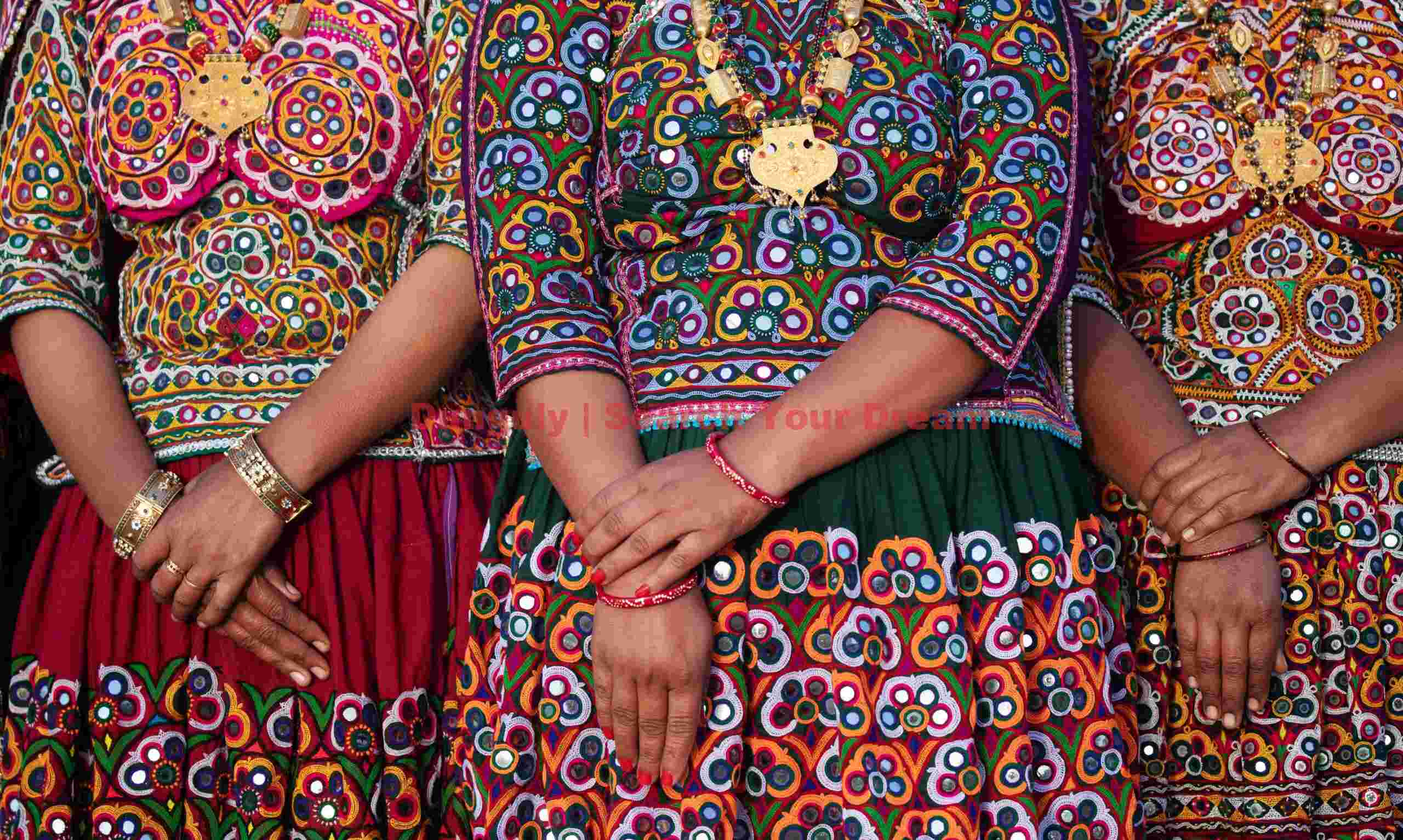 Three pairs of clasped hands