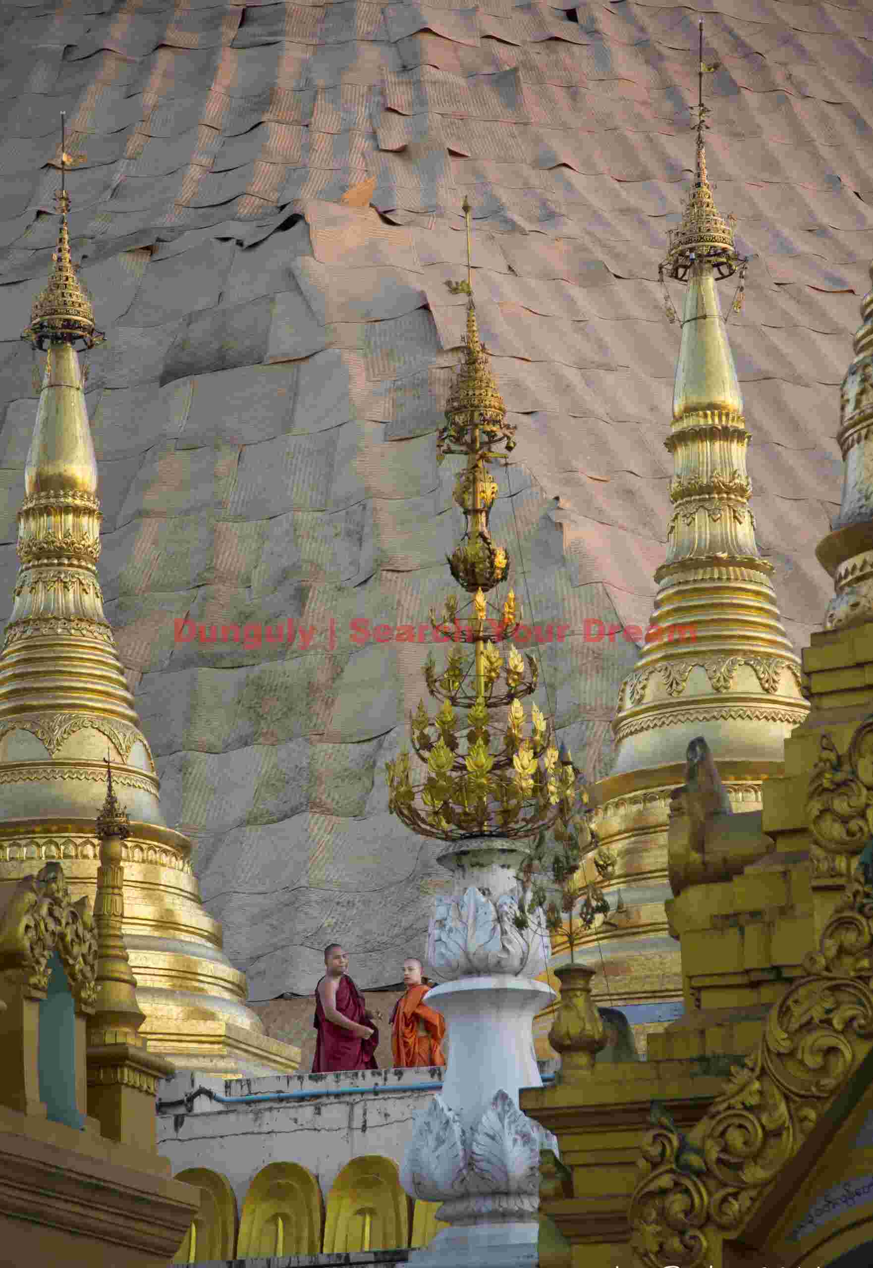 Two monks among spires of the Shwedagon Pagoda