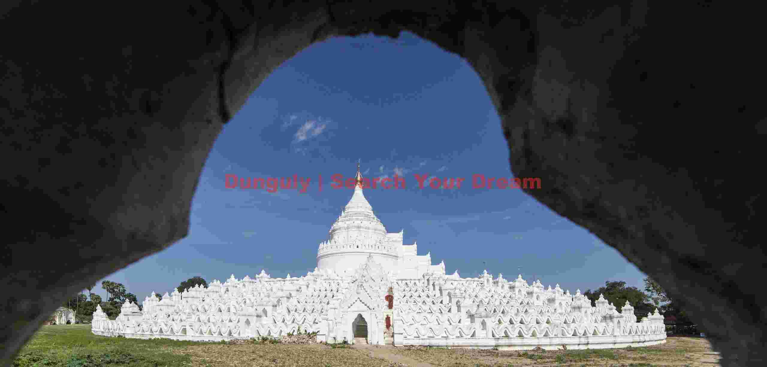 White terraced pagoda with monks descending steps