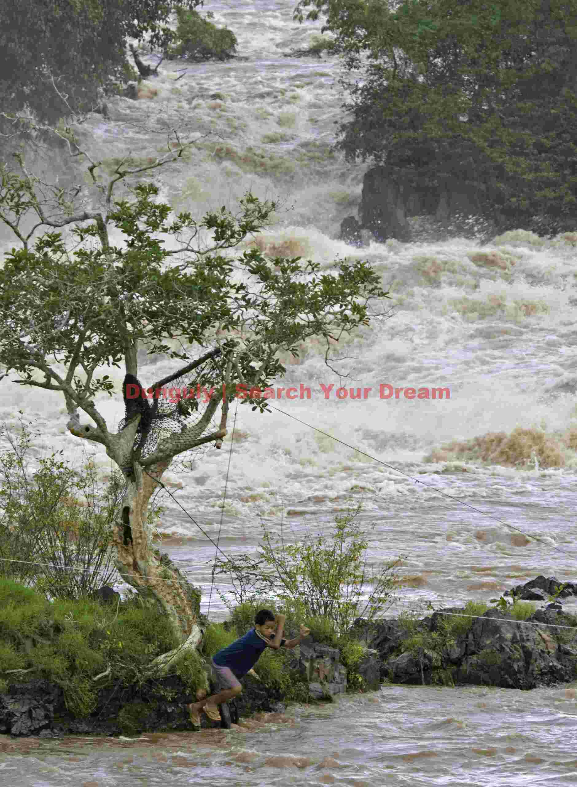 Young fisherboy going hand-over-hand across fixed lines