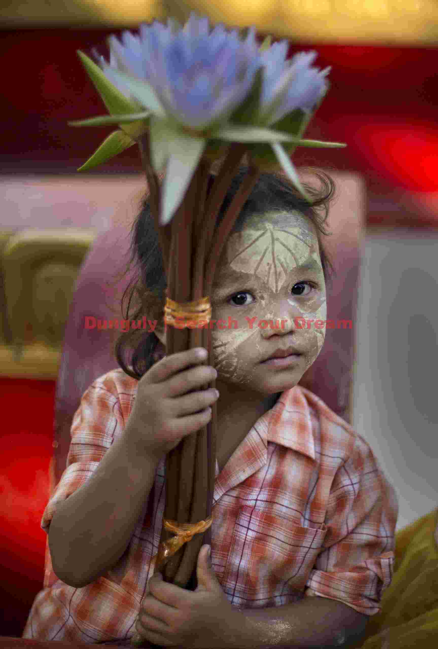 Young girl with blue flower